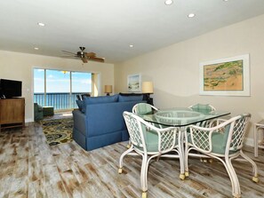 Spacious living room with view out to Lanai, the beach and azure waters of the Gulf of Mexico...large HDTV, stereo, and more...