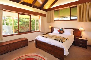 Master bedroom with queen bed and pool outlook.