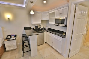 Kitchenette with 2 Induction Stovetop burners, pots, pans, table settings