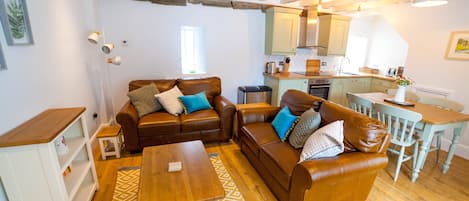 Open plan lounge area in cosy Colby Cottage.