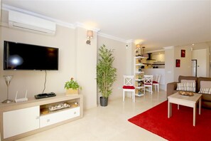 Modern and bright lounge with comfortable seating, international TV and A/C