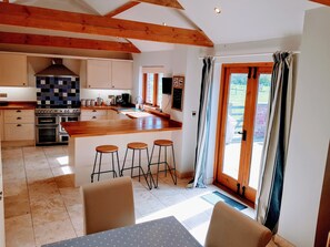 Dining kitchen with doors to courtyard. 