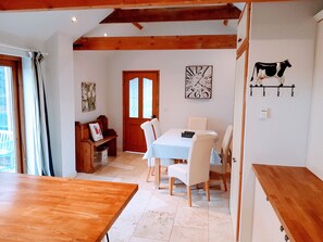 Kitchen dining area. Doors to courtyard and garden
