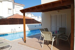 Pergolia and patio area by pool