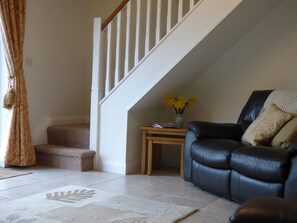 Oak coffee tables and sideboard complement the leather sofas