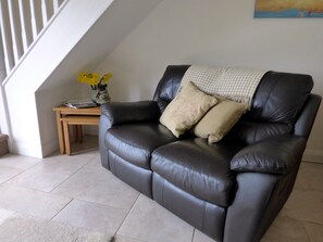 Leather sofas and oak nest of tables in the lounge