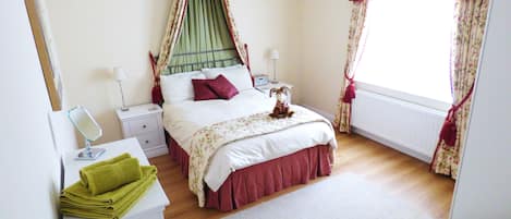 Master bedroom with double bed and canopy over