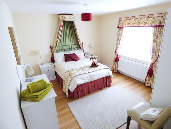 Master bedroom with double bed and canopy over