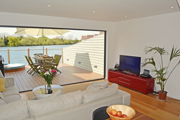 Ground floor: The open plan living area flows out onto the private deck  with hot tub