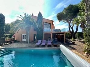 Outside of property showing pool, front terrace and Mediterranean garden
