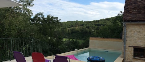 Pool, with sun deck and outdoor table and chairs