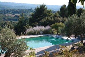 View of pool from the terrace with panoramic view in the background.