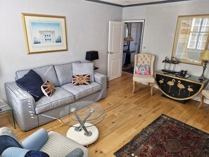 The sitting room is both stylish and spacious. It has Two large sash windows.

