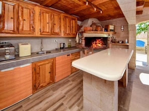 Countertop, Cabinetry, Property, Furniture, Building, Kitchen, Kitchen Appliance, Wood, Kitchen Stove, Interior Design