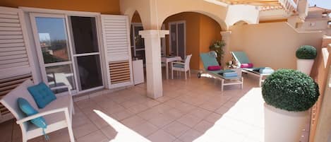 South facing terrace, comfortable sunbeds, beautiful sea-marina view. 