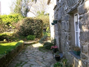 Front of House in sunshine with guests garden to the side