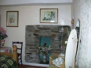 feature fireplace in double bedroom overlooking garden.