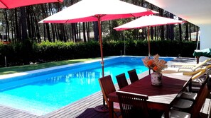 Pool with sunbathing and outside dining area