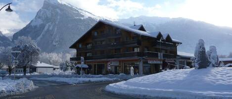 Les Rhodos apartments with ski hire shop, pizzeria and bakery on ground floor. 