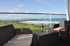 Balcony Furniture with Golf Course and Beach Behind