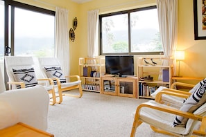 Our warm and welcoming living room with views of Table Mountain to die for.