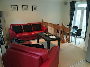 Open Plan Living & Dining area with Juliet balcony also access to garden patio.