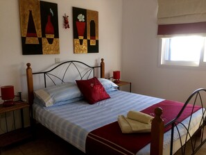 Queen bed with new artwork on the walls.
