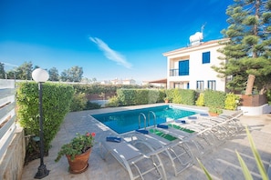 Garden with barbecue, seating area, sun loungers and private pool