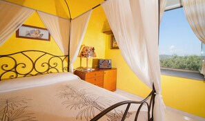 The airy four-poster bed.