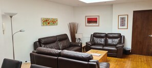 The top floor living room with reclining leather sofas.