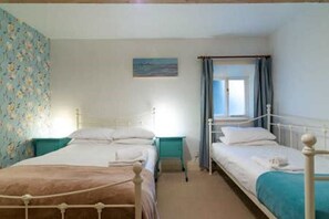 Second bedroom with double bed, single bed and travel cot. 