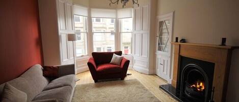 cosy lounge with open fire and bay window