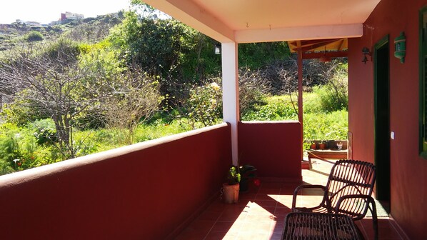 Überdachte Terrasse mit Blick ins Grüne und auf das Meer