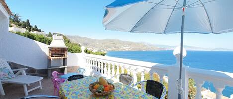 Terrace with dining table and barbecue