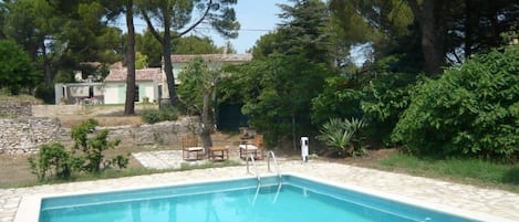 La grande piscine, le  jardin (2700 m)  au milieu des pins et la maison au fond