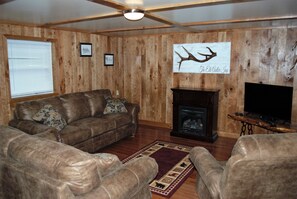 The center piece of the living room is the propane fireplace and custom artwork