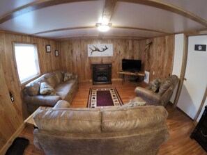 There is plenty of seating in the living room, finished in local cherry wood