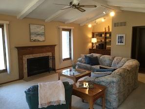 Family room with wood-burning fireplace.