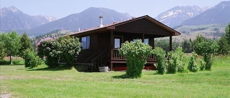 front of cabin with The Absorka Mountain Range as backdrop