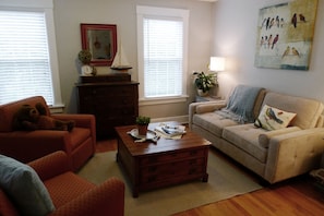 The living room has comfortable seating and can be closed off via French doors