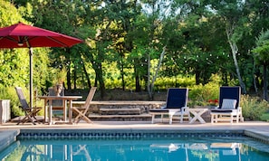 Vineyard beyond pool and custom stone spa