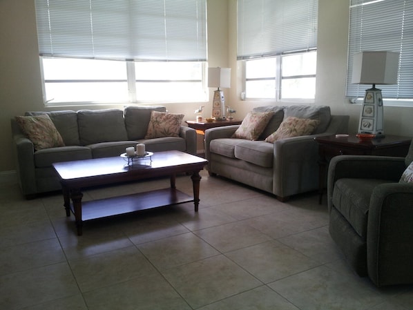 Large comfortable living room with surrounding view of the beach 