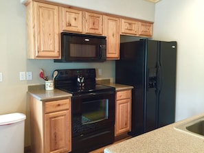 Fully stocked kitchen with a air popcorn popper and basic spices. 