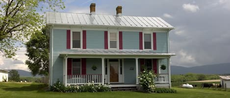 The farm house, recently painted light blue.