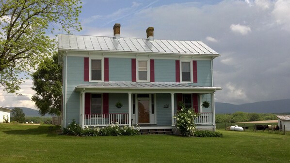 The farm house, recently painted light blue.