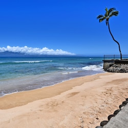 Sandy beach in front of complex