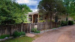 Front gate and porch with peach, pinon and aspens on our private lane