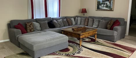 Spacious Living room with massive sectional couch.