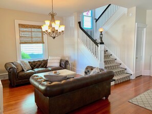 Living Room with leather Chesterfield sofas, and expandable coffee table