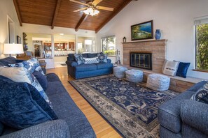 Enjoy peek ocean views, a fireplace and plenty of seating in the living room.